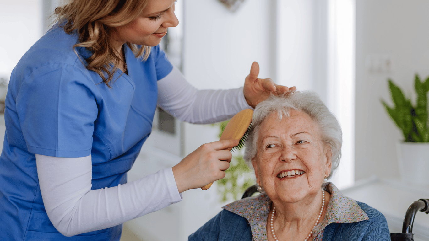 Caregiver assisting a senior with dementia with hygiene through in home care.